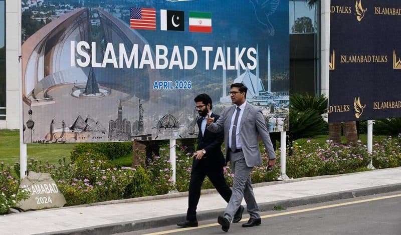 People walk past the press center for the talks between the United States and Iran in Islamabad, Pakistan, April 11, 2026. (Xinhua/Wang Shen)